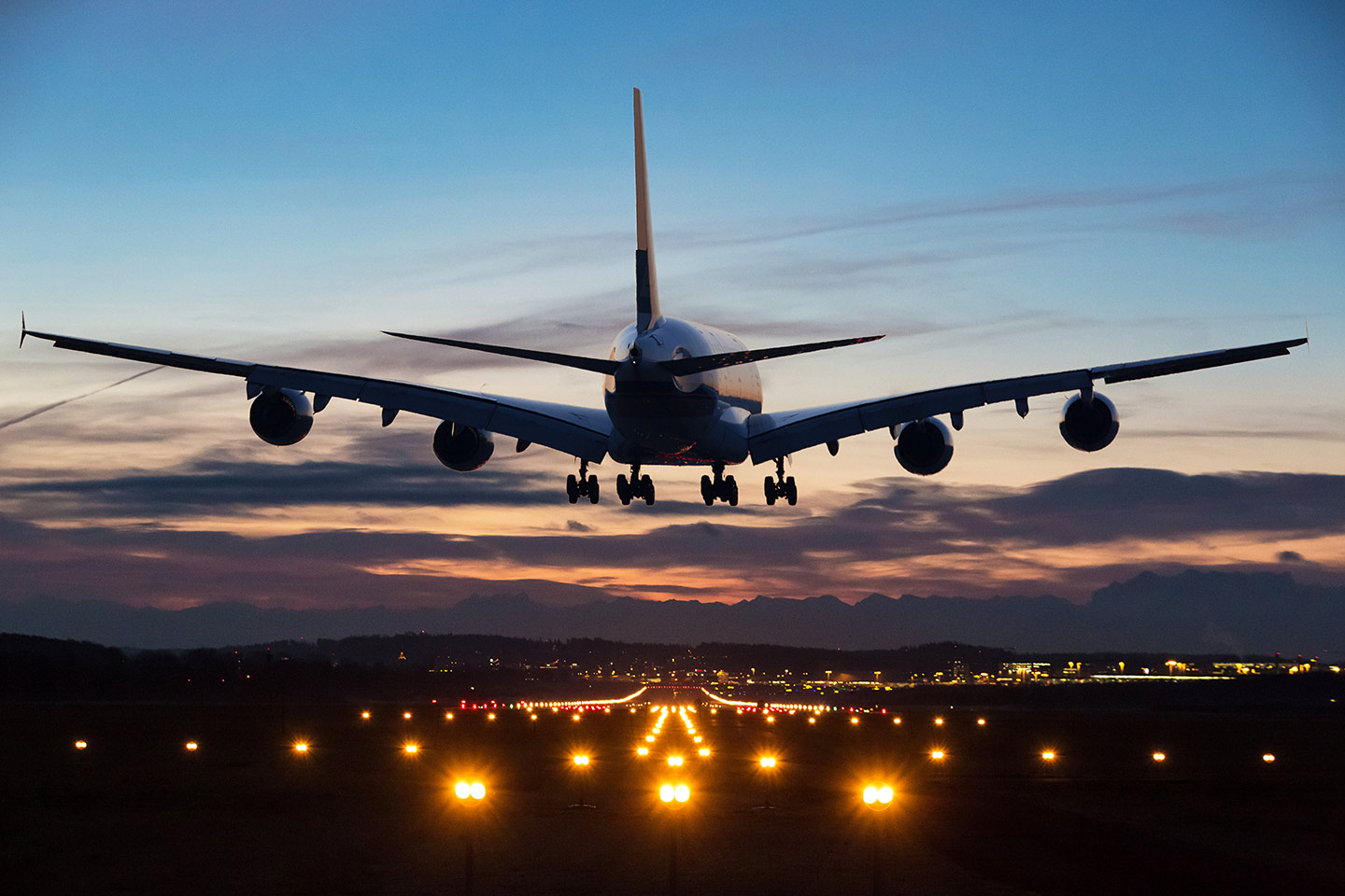 Commercial airliner landing in New Orleans at sunrise